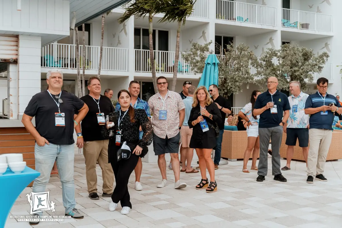 Vendor presenting new equipment to park operators at industry event.